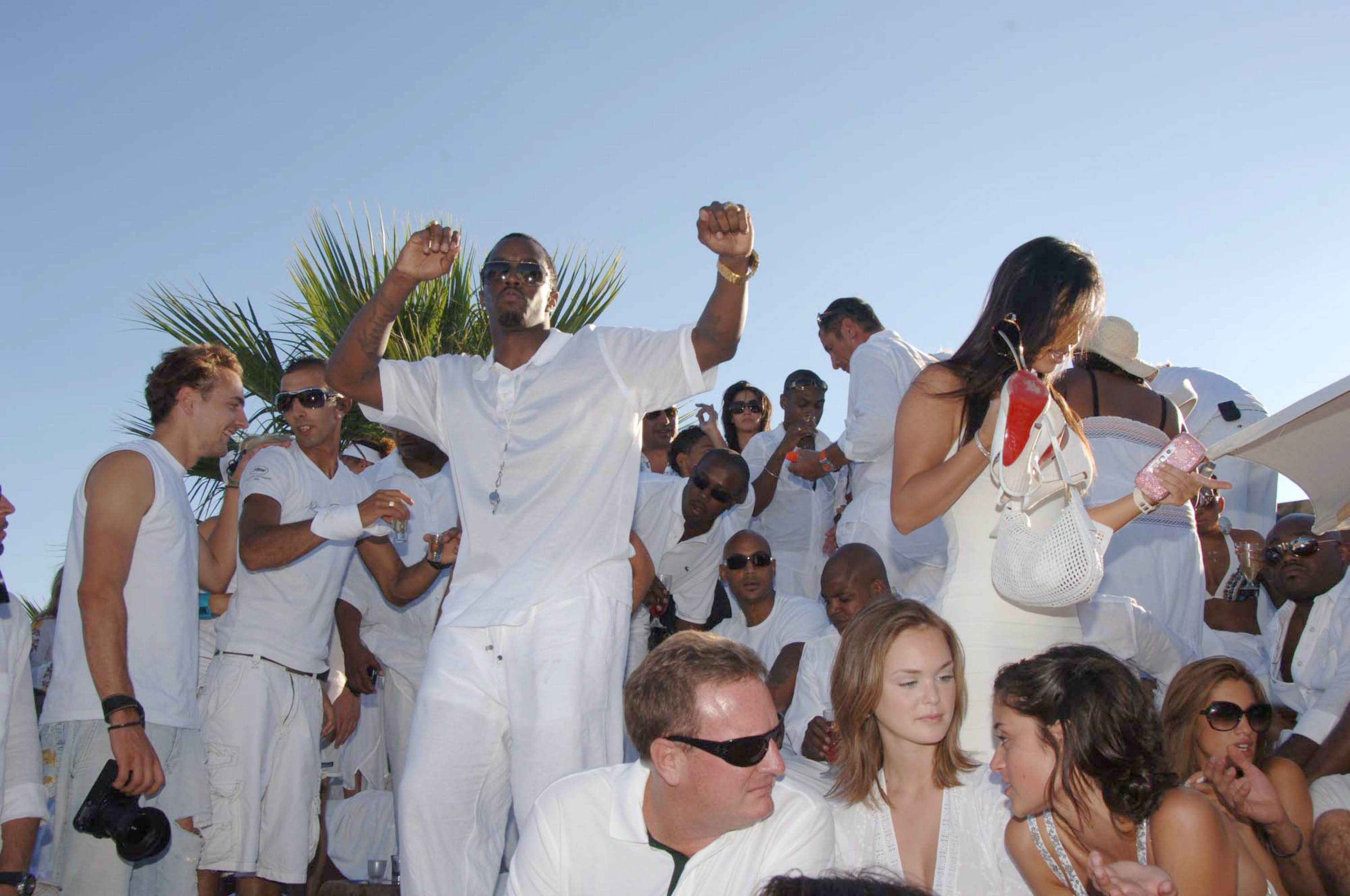 Sean "Diddy" Combs and guest during Sean "Diddy" Combs White Party - Inside at Nikki Beach in St Tropez, France. **Exclusive** (Photo by Jon Furniss/WireImage for MAC Cosmetics)