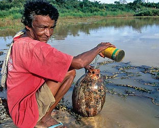 Maria Lacerda, 49, pega água com a cabaça