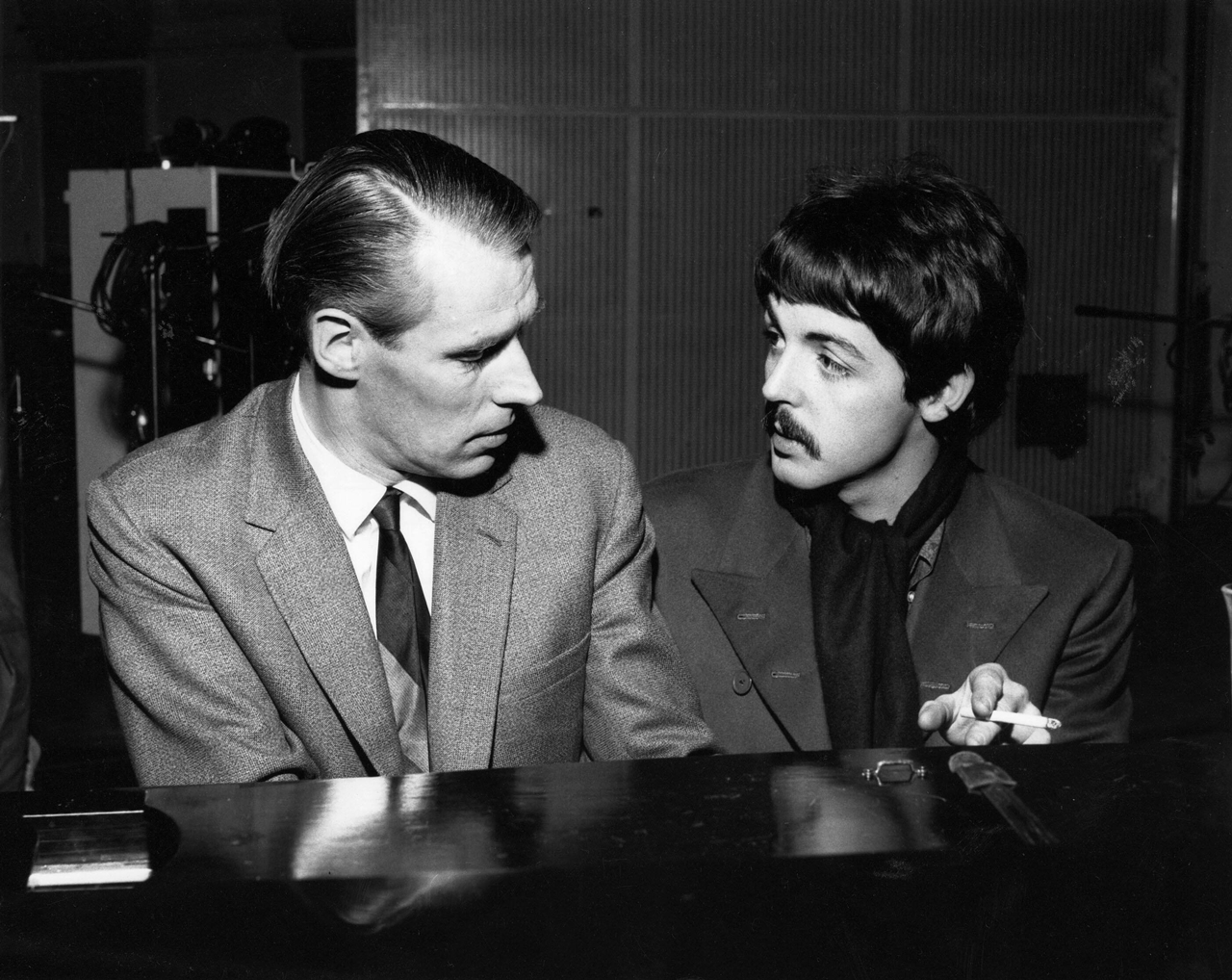 O produtor George Martin e Paul McCartney trabalhando em estúdio em 1966