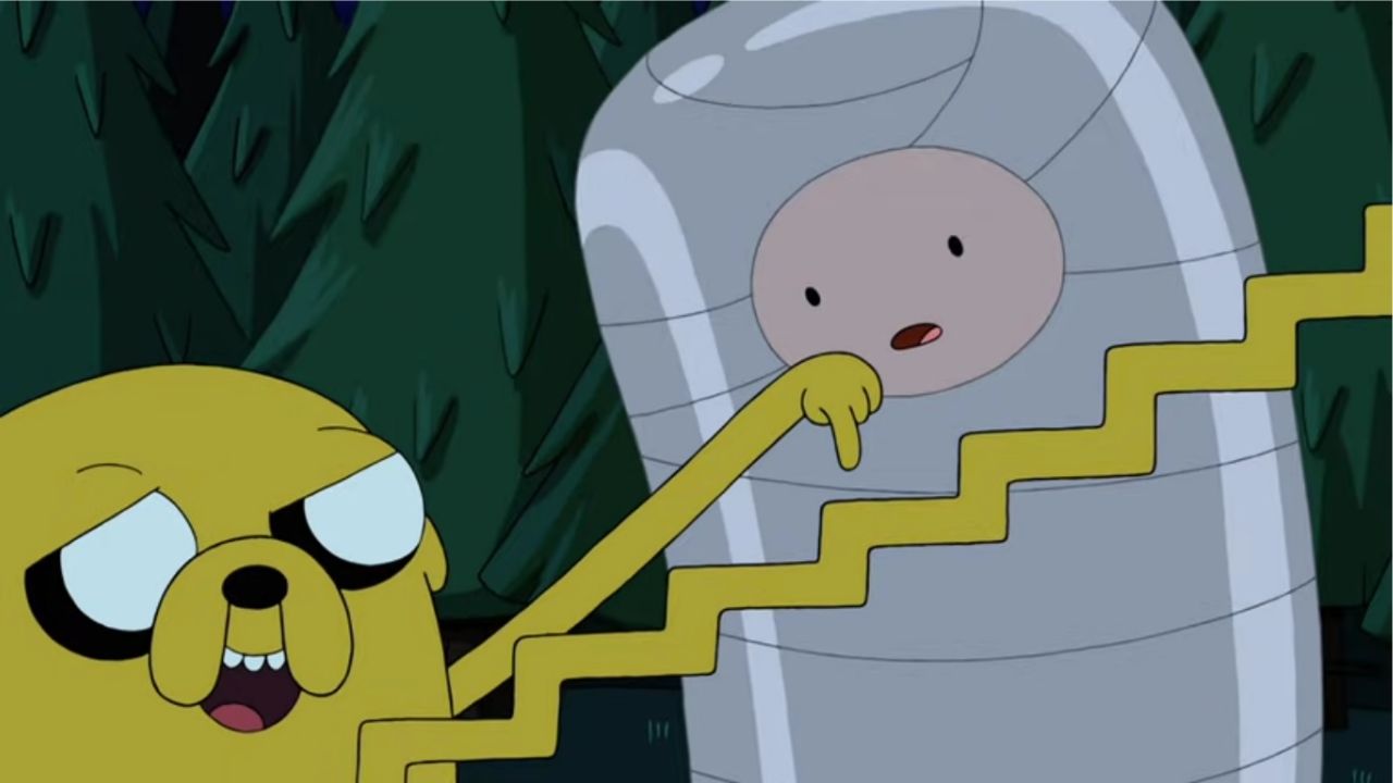 Jake com o braço transformado em uma pequena escada. Finn observa, enrolado em papel alumínio.